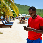 **

"A fully clothed tourist in Antigua and Barbuda, cautiously interacting with a friendly-looking local offering a tour. The tourist is double-checking information on their phone. Background shows a sunny beach and resort. Professional photography, realistic style, safe for work, appropriate content, modest clothing, perfect anatomy, natural pose, high quality."

**